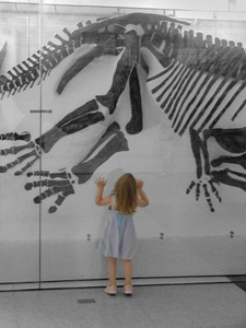 girl under dinasour picture